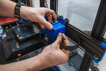 Close-up of technician doing 3D printer repair.