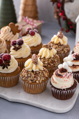 Variety of Christmas cupcakes on a marble tray