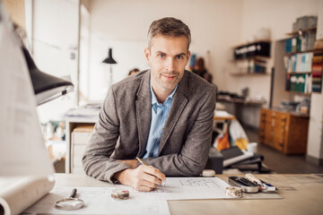 Potrait of a Middle aged male designer working in a startup company office