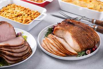 Oven roasted turkey breast thinly sliced with side dishes for a celebration dinner
