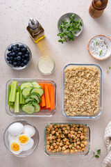 Vegetarian lunch meal prep in containers, high protein with quinoa, herbed chickpeas, vegetables and boiled eggs