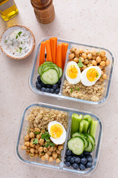 Vegetarian lunch meal prep containers high protein with quinoa, herbed chickpeas, vegetables and eggs