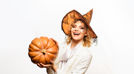 Halloween holiday. Smiling woman in witch hat with big pumpkin. Trick or treat. Happy Halloween. Halloween party girl with Jack-o-lantern. Woman witch with carving pumpkin. 31 October. Halloween sale.