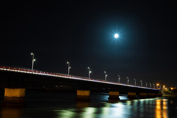 old bridge at night with light