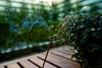 An incense stick is smoking on the terrace
