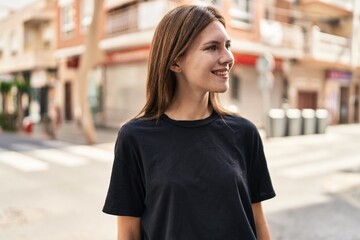 Young blonde woman smiling confident looking to the side at street