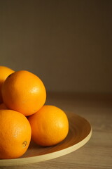 Several juicy oranges in a plate