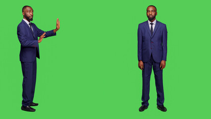 Negative businessman doing stop sign with palm raised, showing disapproval and rejection. Displeased office worker in formal suit expressing refusal and saying no, disagreement symbol.