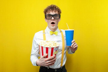 guy in festive outfit in 3d glasses watches movie with popcorn, nerd student in bow tie and...