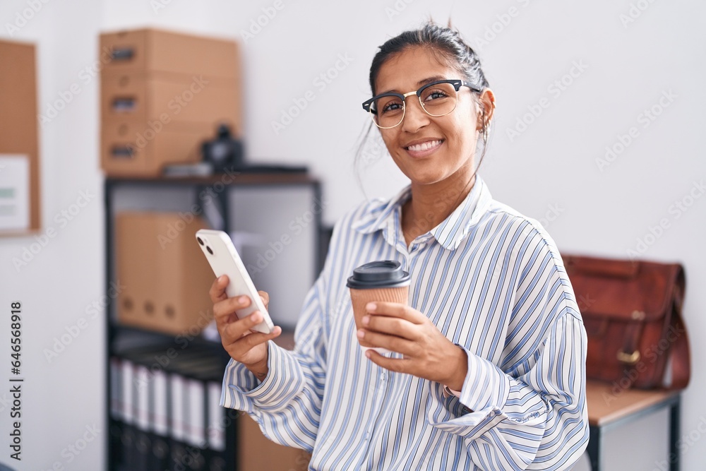 Sticker Young beautiful hispanic woman business worker using smartphone drinking coffee at office