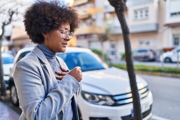African american woman executive coughing at street