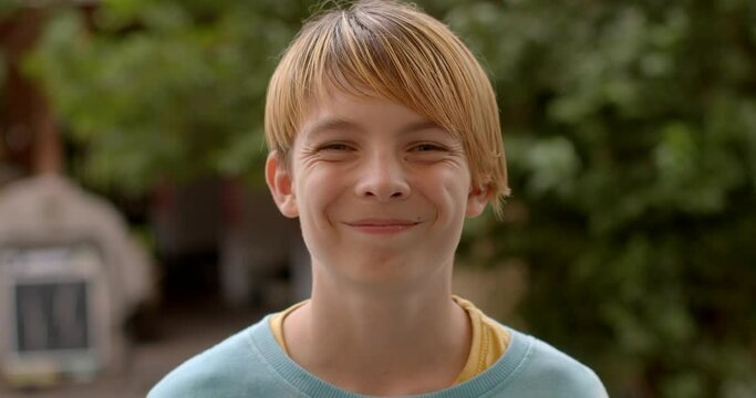 Portrait teenager smiles playfully but it's a fake smile, indicates that the individual is putting on a facade of happiness or amusement. People lifestyle social situations to conform to social norms