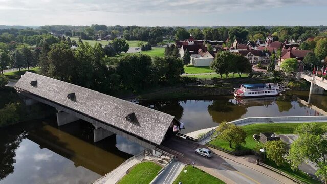 A reverse aerial view of the Frankenmuth covered bridge over the Cass River.  	