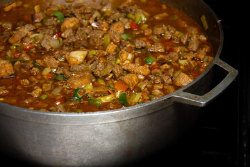 Caldero in the kitchen with Stew prepared with beef, pork and chicken for hallacas. Venezuelan typical dish