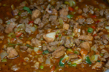 Caldero in the kitchen with Stew prepared with beef, pork and chicken for hallacas. Venezuelan typical dish