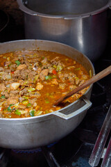 Caldero in the kitchen with Stew prepared with beef, pork and chicken for hallacas. Venezuelan typical dish