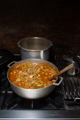 Caldero in the kitchen with Stew prepared with beef, pork and chicken for hallacas. Venezuelan typical dish