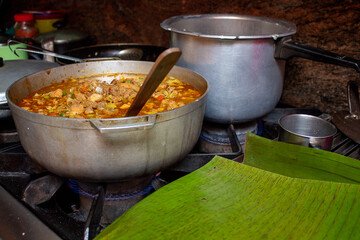 Caldero in the kitchen with Stew prepared with beef, pork and chicken for hallacas. Venezuelan typical dish