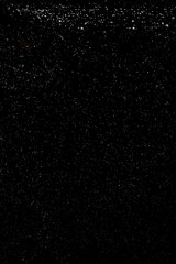 Fototapeta premium small white air bubbles in water on black background