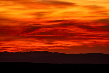 Brilliant Red and Orange Bands Through Clouds in Big Bend