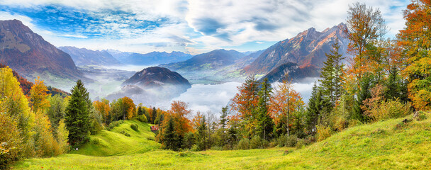Outstanding autumn view on suburb of Stansstad city  and Lucerne lake with mountaines and fog. - obrazy, fototapety, plakaty