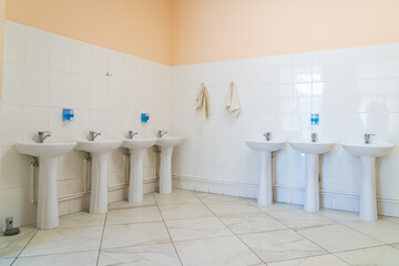 Washbasins in the hostel or public toilet. Background with selective focus and copy space