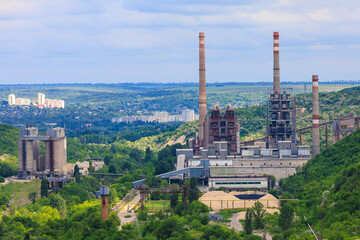 Plant or factory. Industrial area in a picturesque beautiful green area. Background with selective focus and copy space