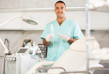 Portrait of friendly doctor in beauty clinic, in the ward of hardware procedures for facial skin rejuvenation