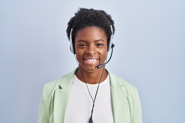 African american woman wearing call center agent headset with a happy and cool smile on face. lucky person.