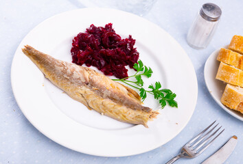 Hot smoked mackerel fish fillet garnished with grated beetroot salad, mediterranean food