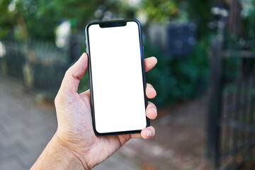 Man holding smartphone showing white blank screen at street