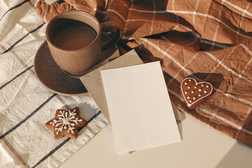 Winter festive still life. Cup of coffee, Star and heart shaped gingerbread cookies on checkered table cloth in sunlight. Christmas breakfast concept. Blank greeting card, invitation mockup. Flatlay