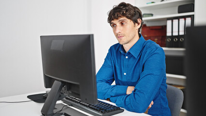 Young hispanic man business worker using computer working at the office