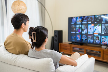 Couple watch TV at home