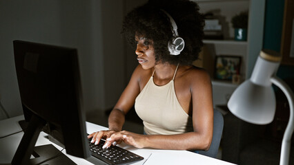 African american woman business worker using computer and headphones at the office
