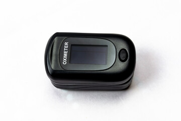Digital pulse oximeter on white background.