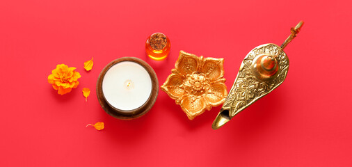Lamp with candle and oil on red background. Indian holiday Diwali (Festival of lights)