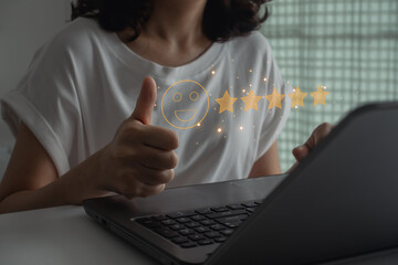 Customer satisfaction concept, thumbs up icon right with a smile. Happy woman client using laptop...