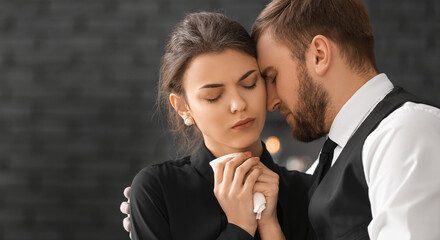 Couple pining after their relative at funeral