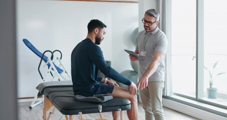 Physiotherapist, man and consultation for joint pain with tablet and medical support in a physical therapy clinic or rehabilitation. Physio, doctor and consulting person or advice for healing injury