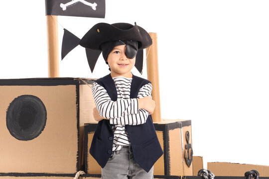 Cute little pirate with cardboard ship on white background