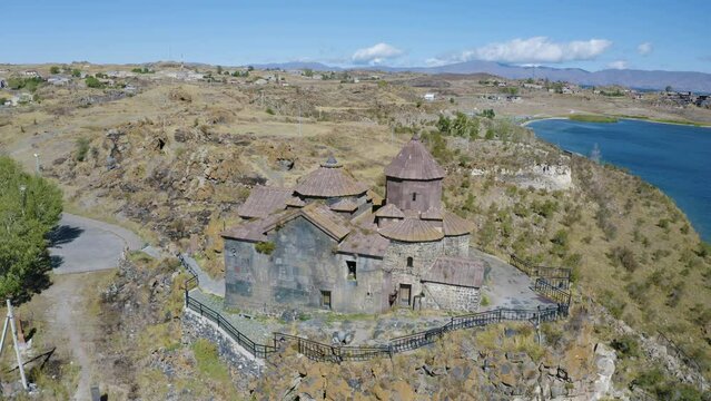 Orbital aerial shot of Hayravank Monastery and Sevan Lake on sunny summer day. Gegharkunik Province, Armenia.