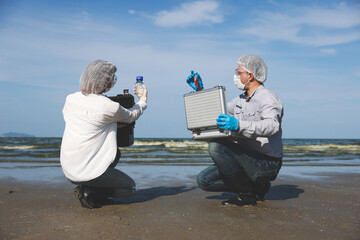 A couple of environmentalists collected and examined the quality of water on the beach polluted...