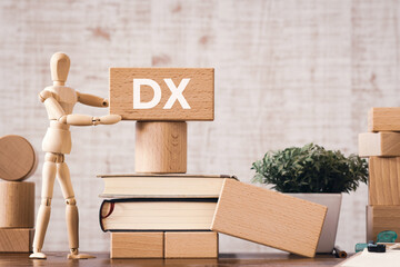 There is wood block with the word DX. It is an abbreviation for Digital Transformation as eye-catching image.