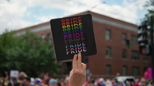 Hand Hold Pride Flyer And People At Pride Parade On Pride Parade