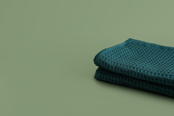 Folded clean napkins on color background