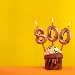 Number 800 anniversary candle - Celebration on yellow background