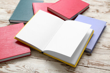 Fototapeta premium Open book with blank pages on white wooden table