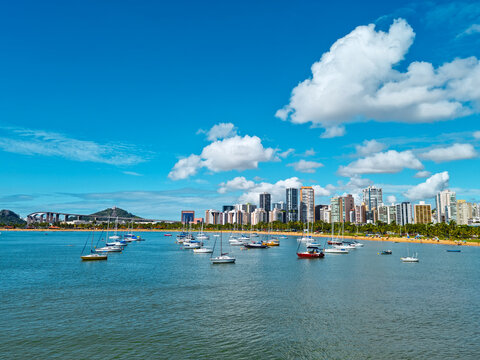 View of the city of Vitoria, capital of  Espirito Santo State, Brazil. Boats in the sea. Beach, buildings, Third bridge and Convent of Penha in the background.