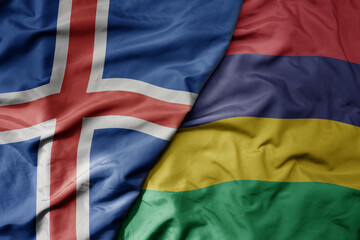 big waving national colorful flag of icelandic and national flag of mauritius .